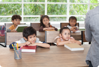 A lively classroom scene with children at desks, collaborating and learning together in a vibrant educational space.