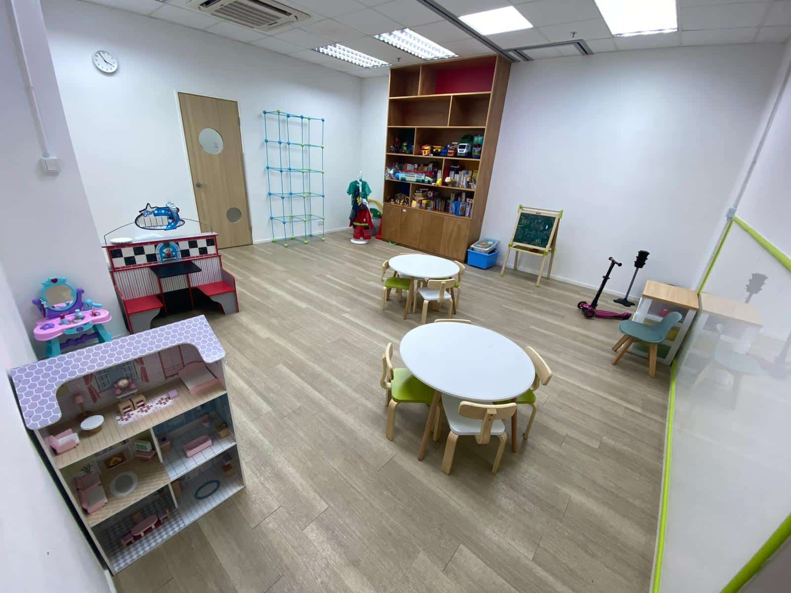  A colorful playroom filled with various shelves and cozy furniture, inviting children to explore and play.